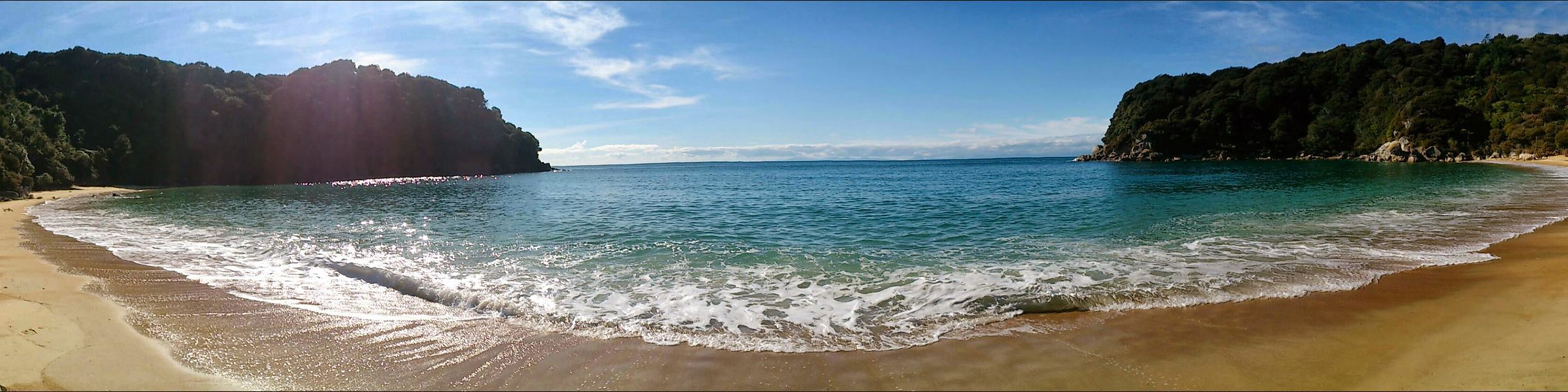The full curve of Kaiteriteri Beach and its headlands