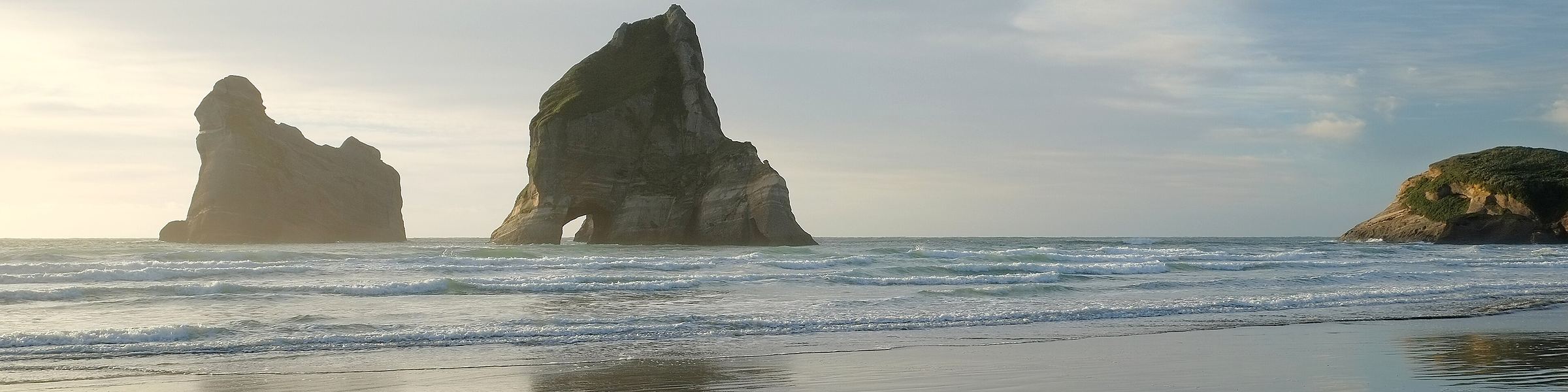 The Archway Islands standing in mist off Wharariki Beach
