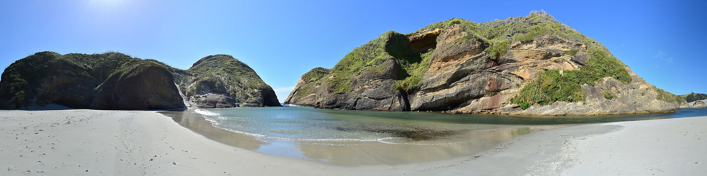 The wide tidal sands and sea-carved islands of Wharariki Beach