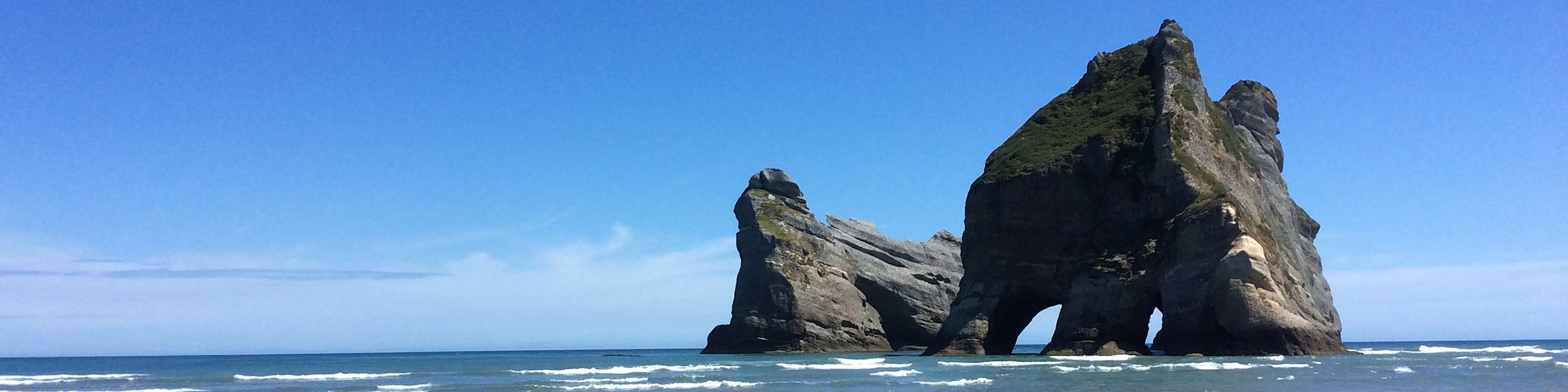 The Archway Islands and their sea arch under a clear sky