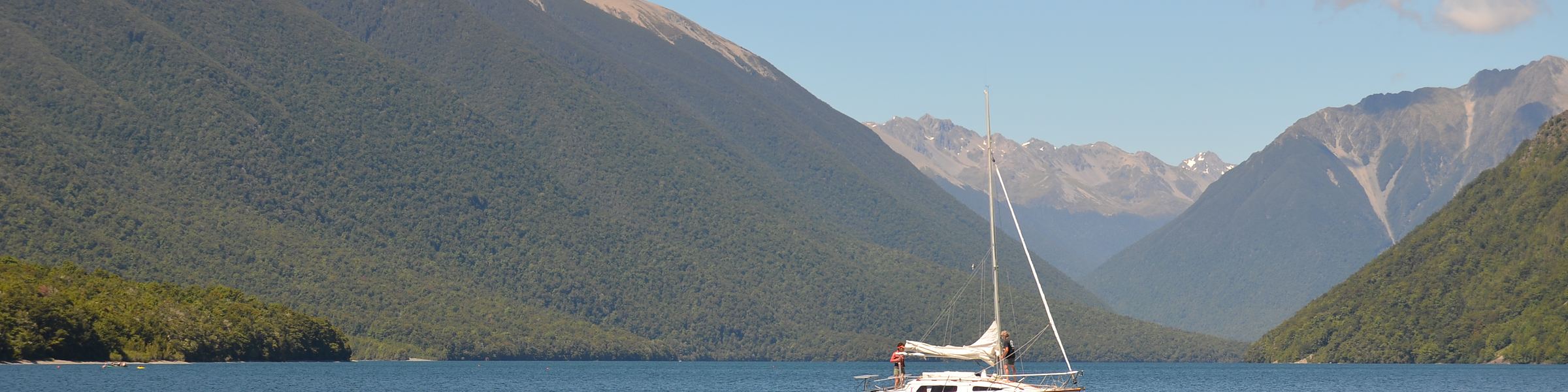 A yacht at anchor on the lake below the Nelson Lakes ranges